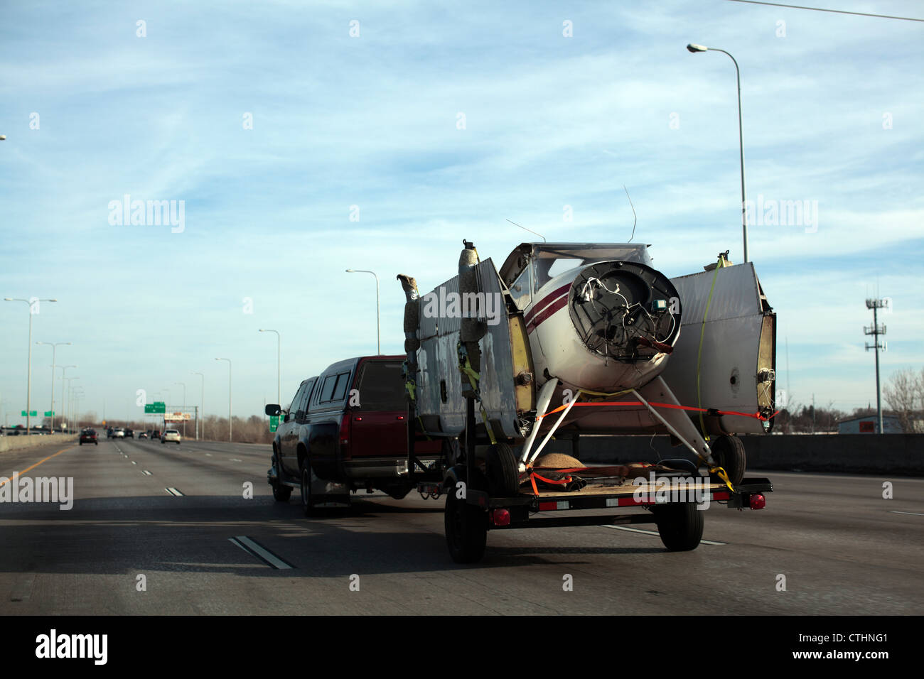 A small plane being transported on a flatbed trailer, disassembled