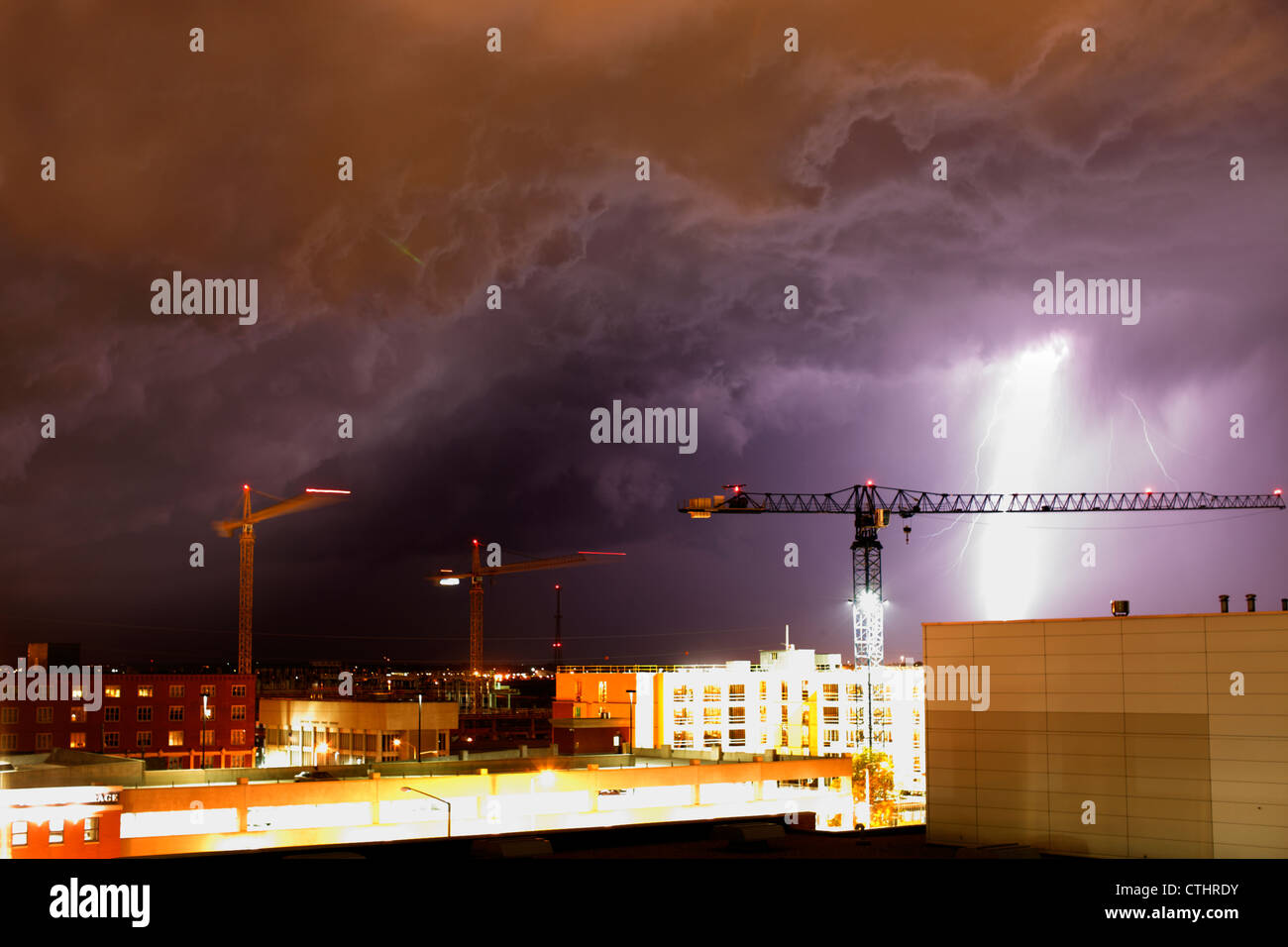 The underside of a severe storm system lit by a lightning strike, with