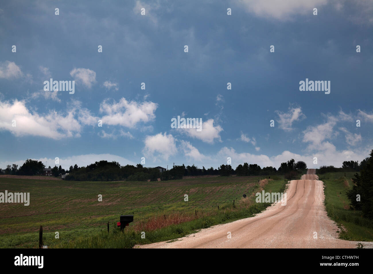 Country road and small clouds Stock Photo - Alamy