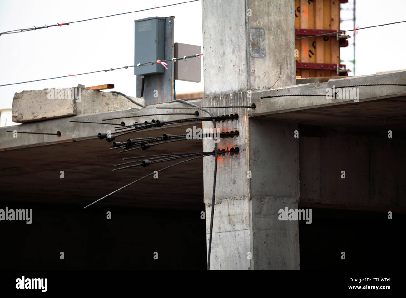 Post tensioning cables protruding from end of concrete structure Stock