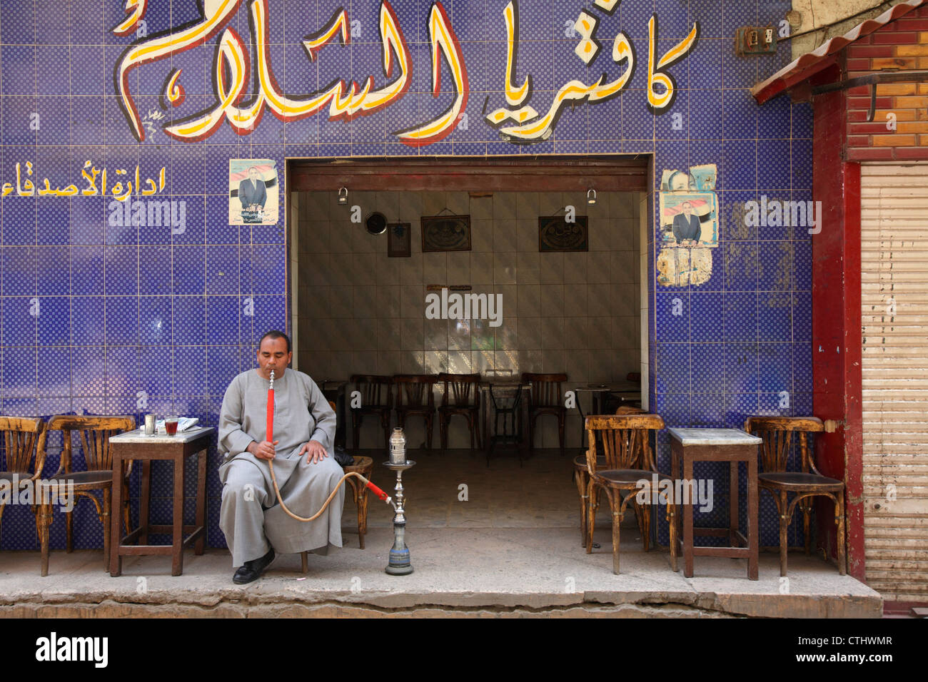 Egyptian man smoking a sheesha at a streetside cafe, Luxor, Egypt Stock Photo