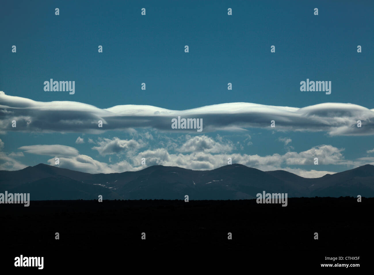 Long lenticular cloud formation over Colorado's Rocky Mountains. Stock Photo