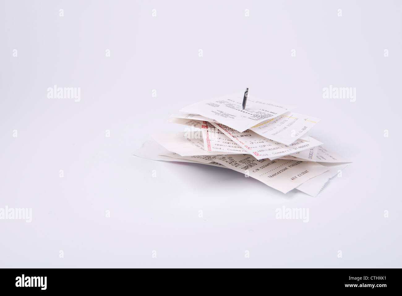 some receipts pinned in the nail Stock Photo