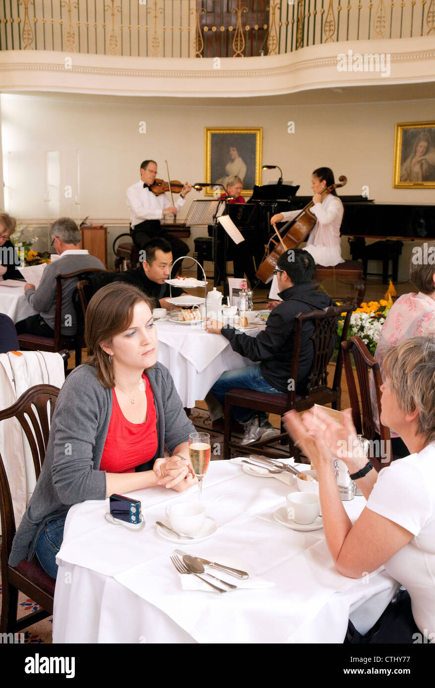 People enjoying Champagne and classical music in the Bath Pump Room Tea