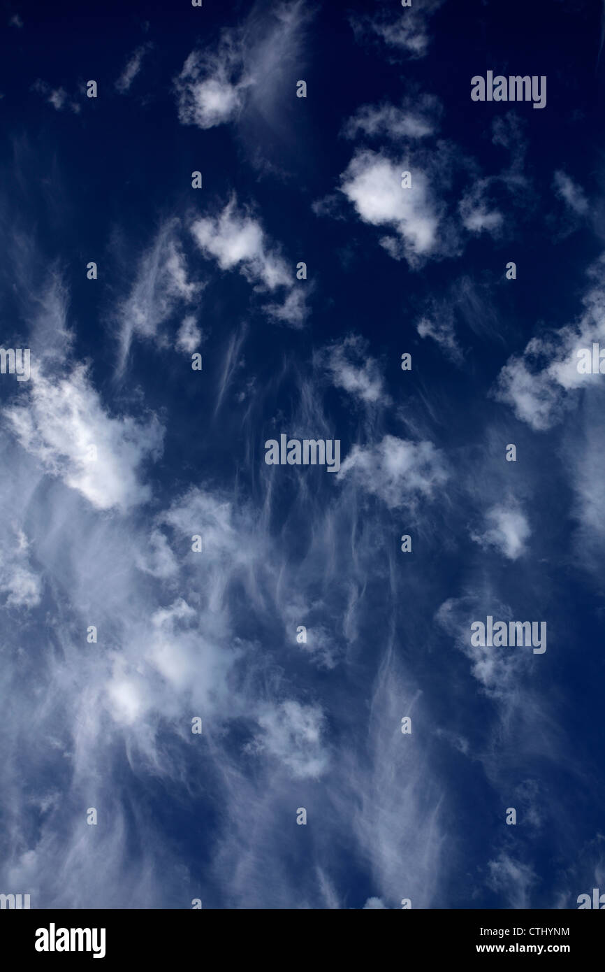 Cirrus clouds against a deep blue sky. Stock Photo