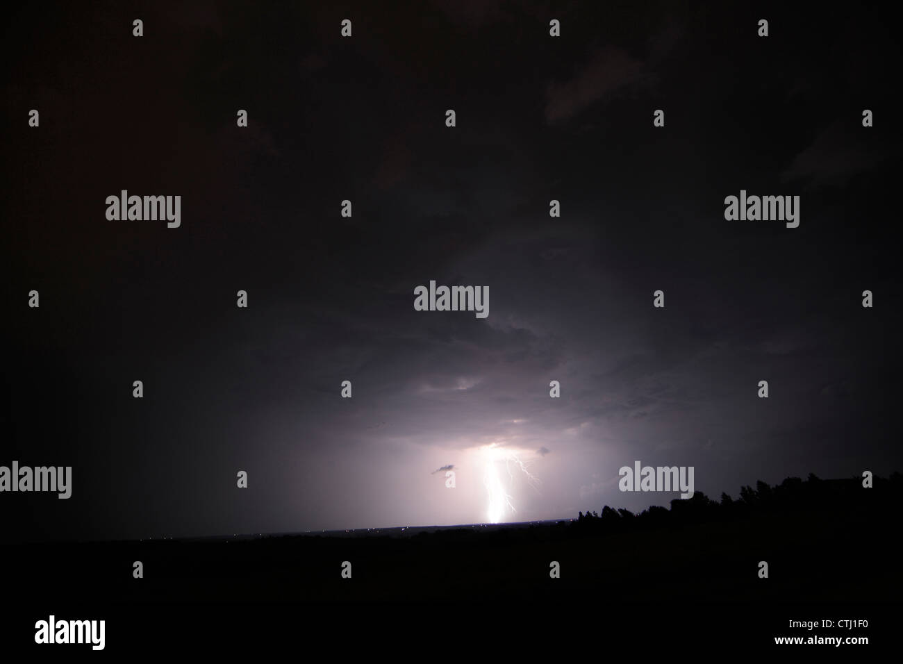 Lightning strike during a thunderstorm at night. Stock Photo