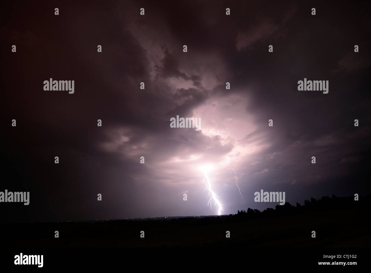Lightning strikes during a night thunderstorm. Stock Photo