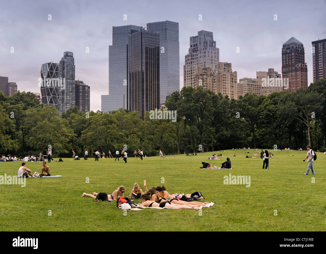 Group of girls sunbathing in Central Park, Manhattan, New York, USA, Stock Photo