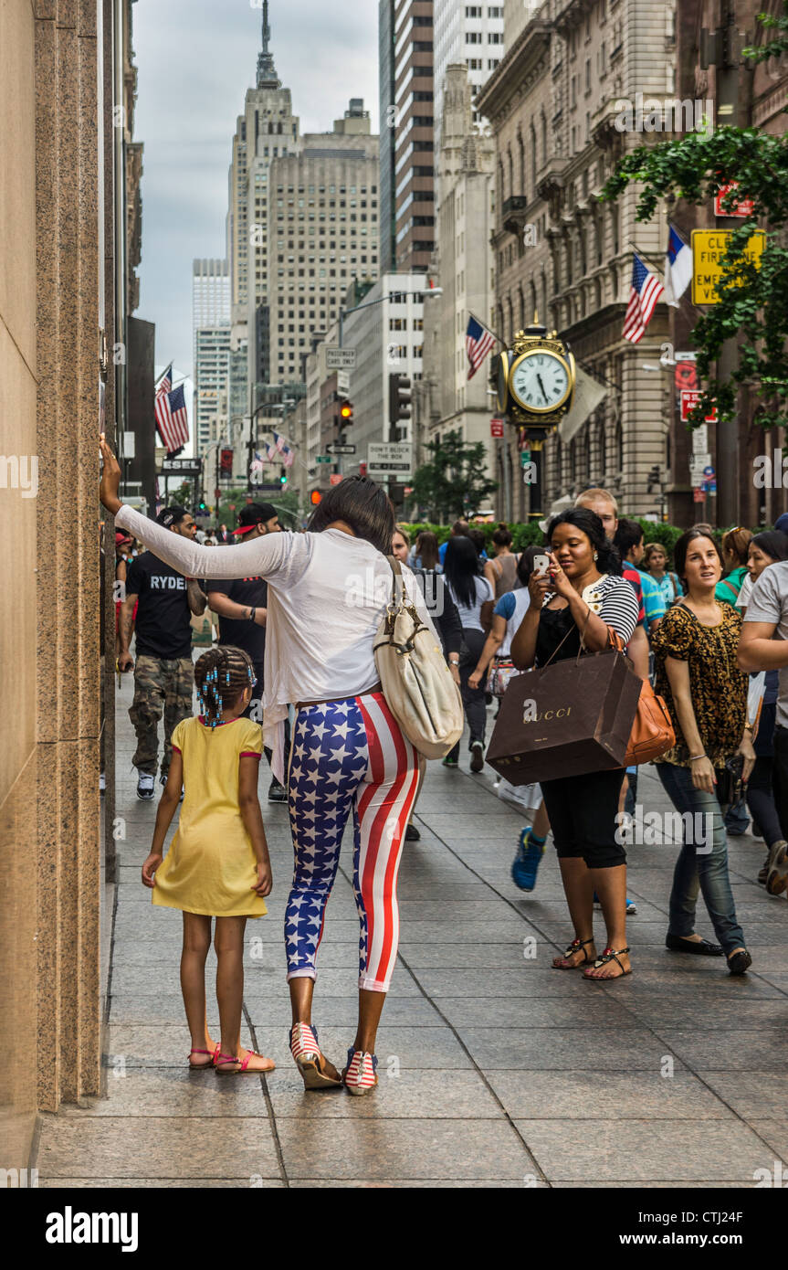 Mother and child posing in front of Trump Tower, stars and stripes trousers, Empire state building, Donald Trump, New York, USA, Stock Photo