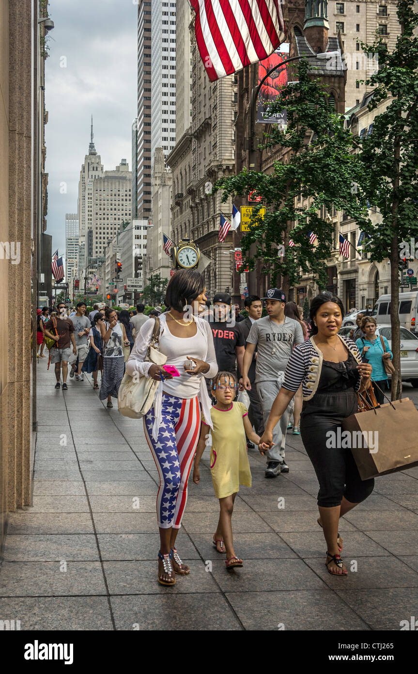 5 th Avenue, street scene, women with stars & stripes trousers, Trump Tower, New York, USA, Stock Photo