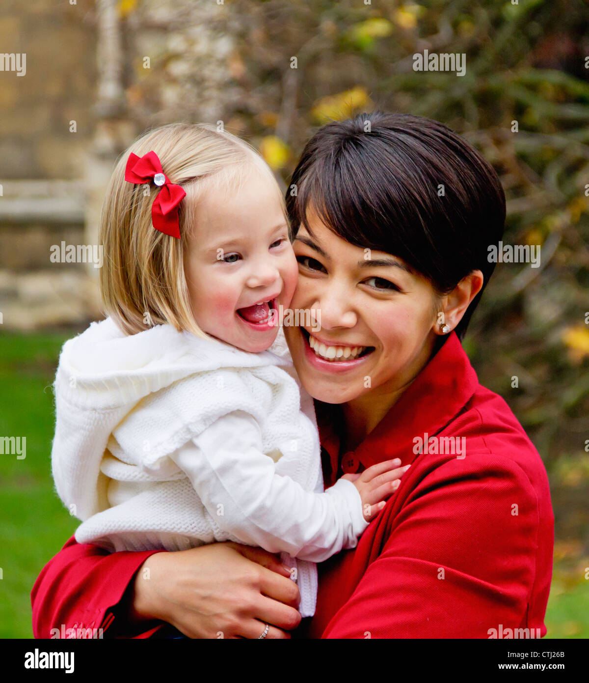 Portrait Of A Mother And Daughter Laughing; Cambridge, England Stock Photo