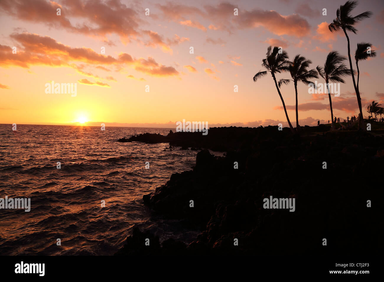Sunset over rocky Hawaiian coastline Stock Photo