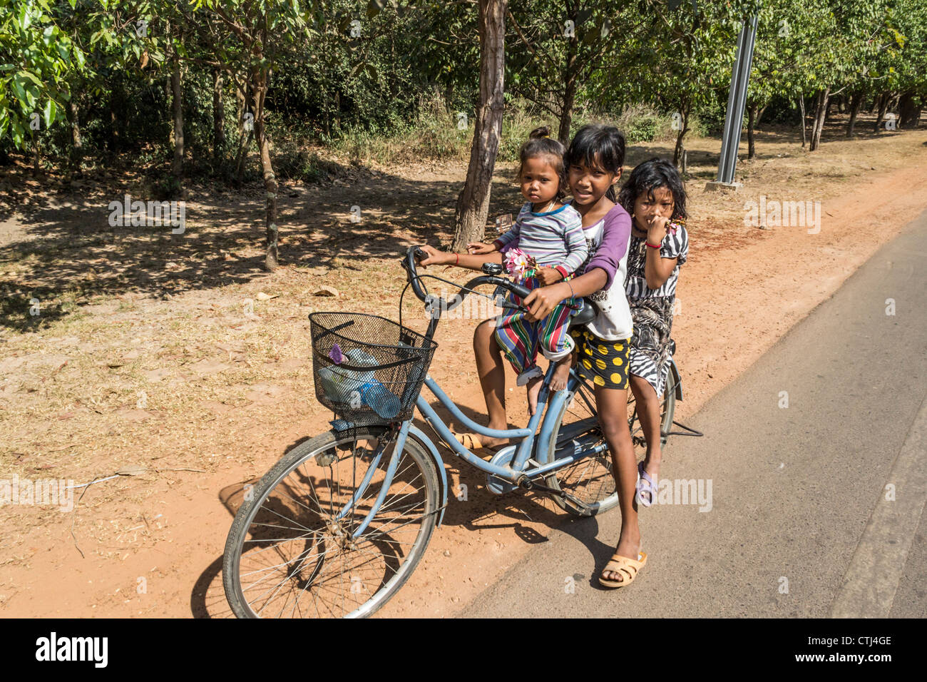 cambodien kids on bicycles on street to Angkor Thom, Cambodia, Asia, Stock Photo