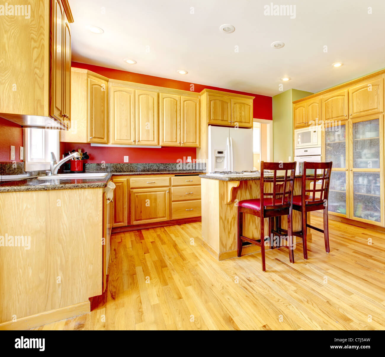 Yellow kitchen with island and yellow wood with red and green colors