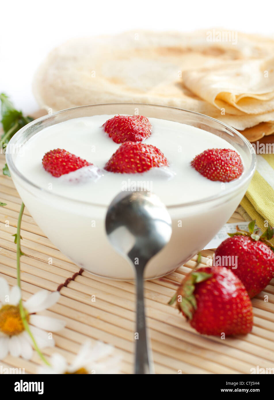 Yogurt with strawberries and flavored pancakes, closeup Stock Photo