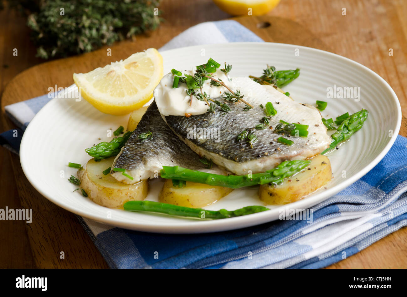 Grilled sea bass with new potatoes Stock Photo Alamy
