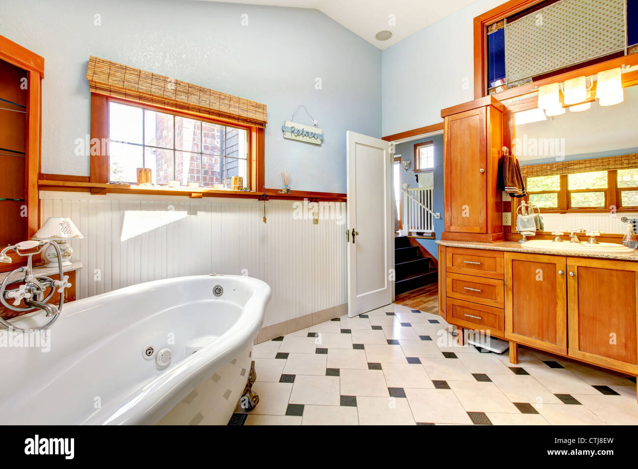 Large classic blue bathroom interior with tub and tiles and wood Stock Photo Alamy