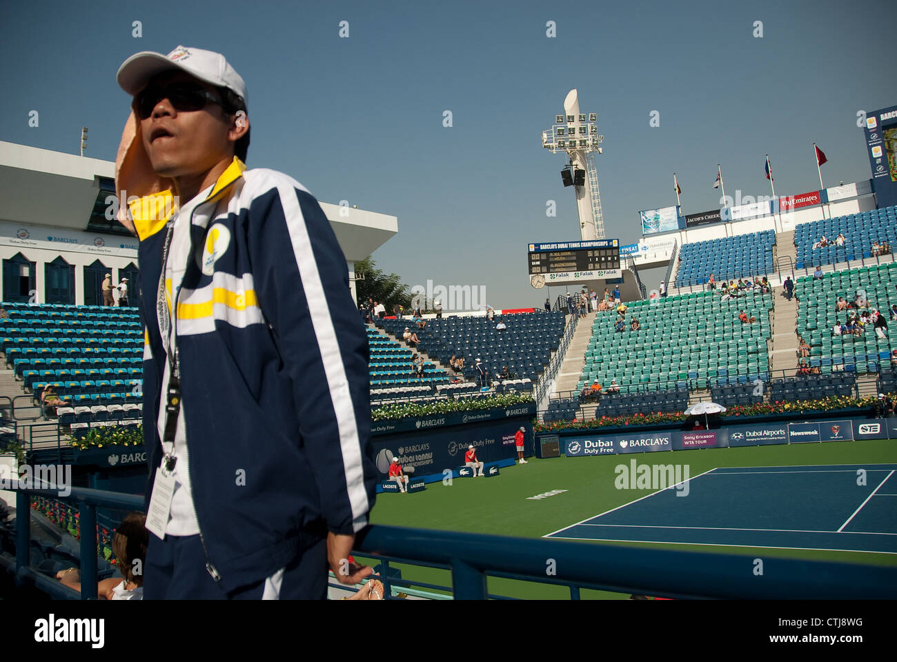 A volunteer takes a break at The Barclays Dubai Tennis Championships Stock Photo