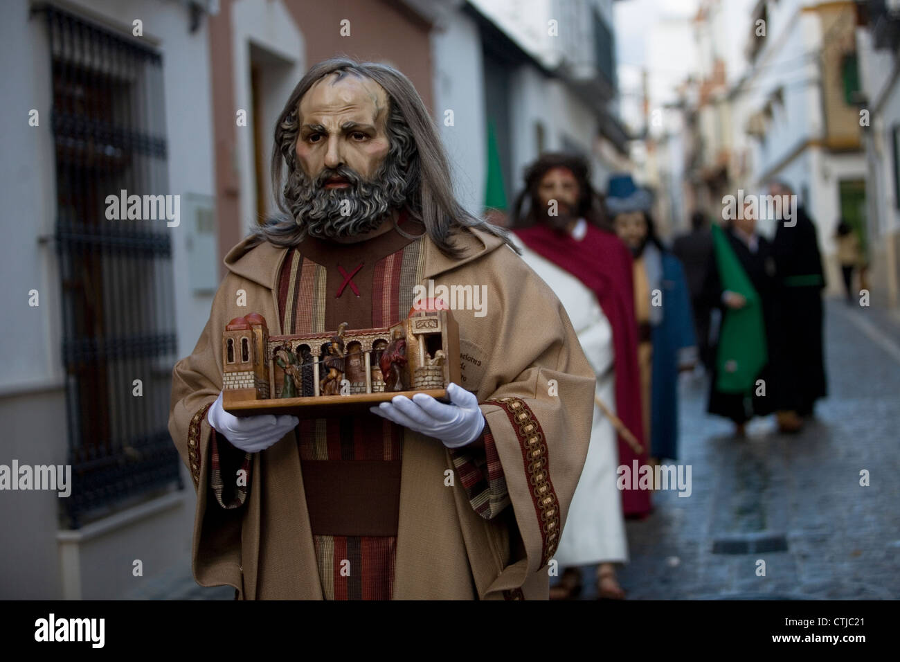 Masked men dressed as biblical characters walk in a street during Easter Holy Week in Puente Genil, Cordoba, Andalusia, Spain Stock Photo