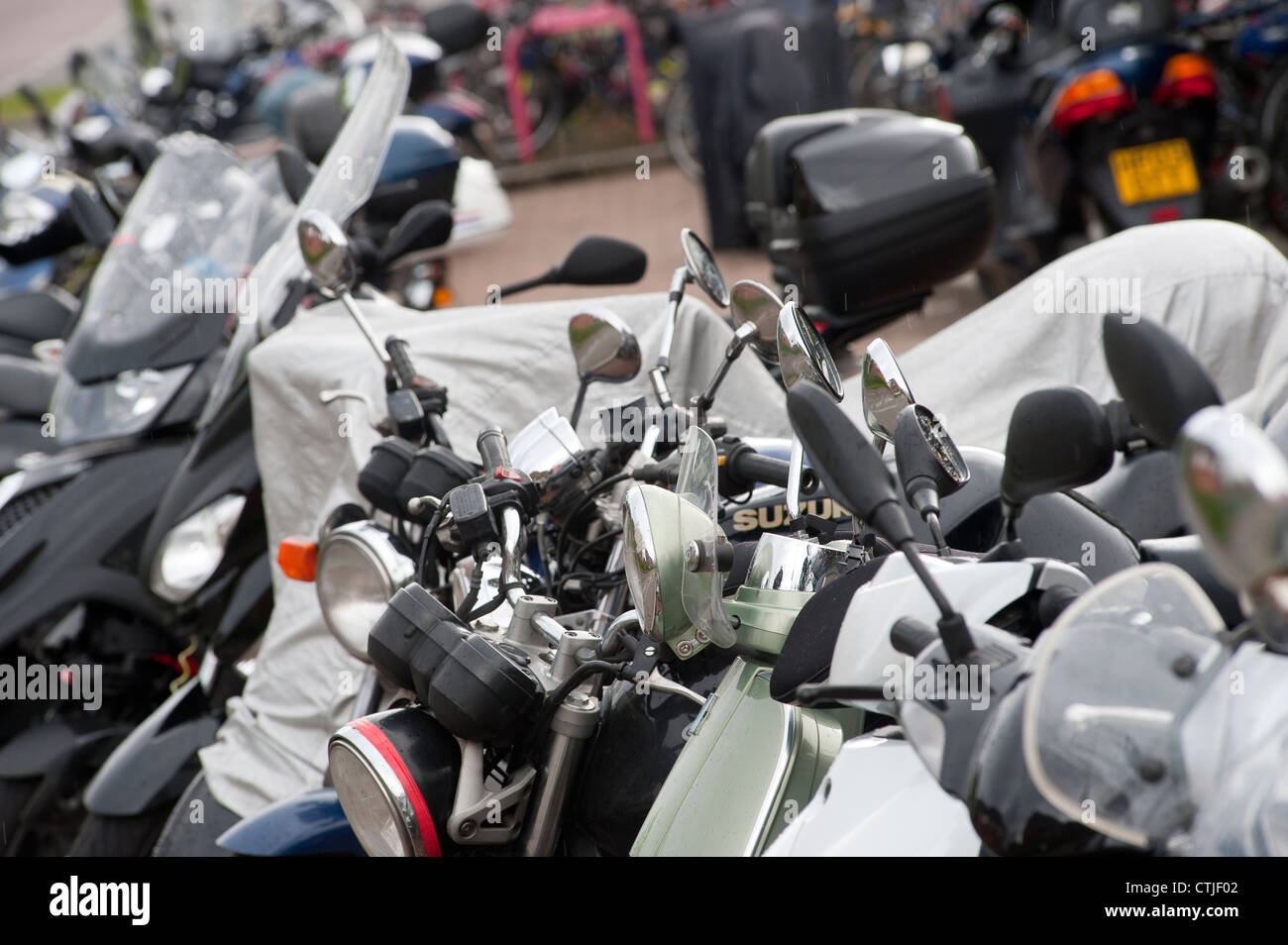 Motorbikes parked securely in a parking area outside a railway station in England. Stock Photo