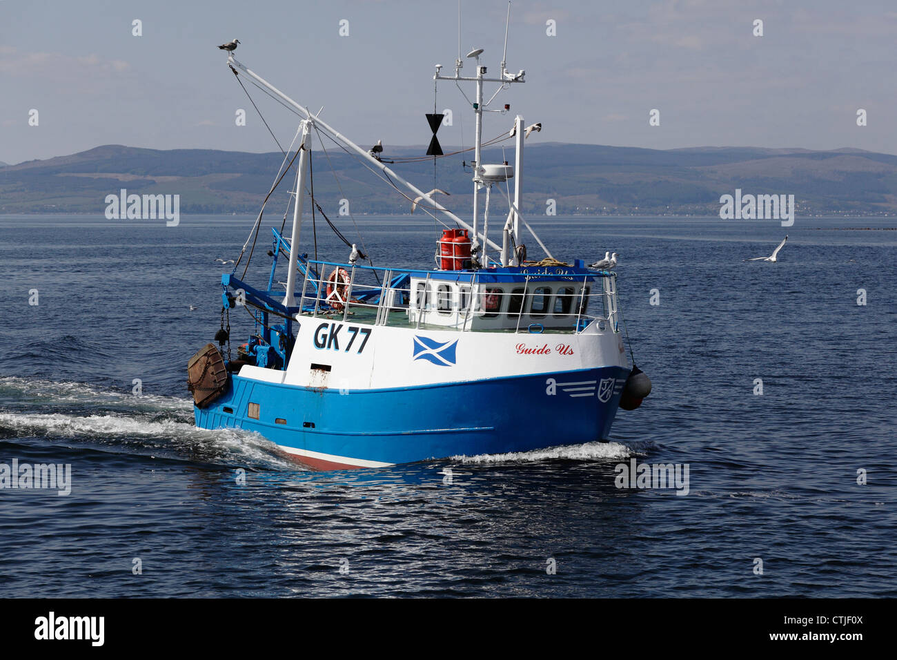 Small fishing boat Guide Us sailing off Largs  in the Firth of Clyde, North Ayrshire, Scotland, UK Stock Photo