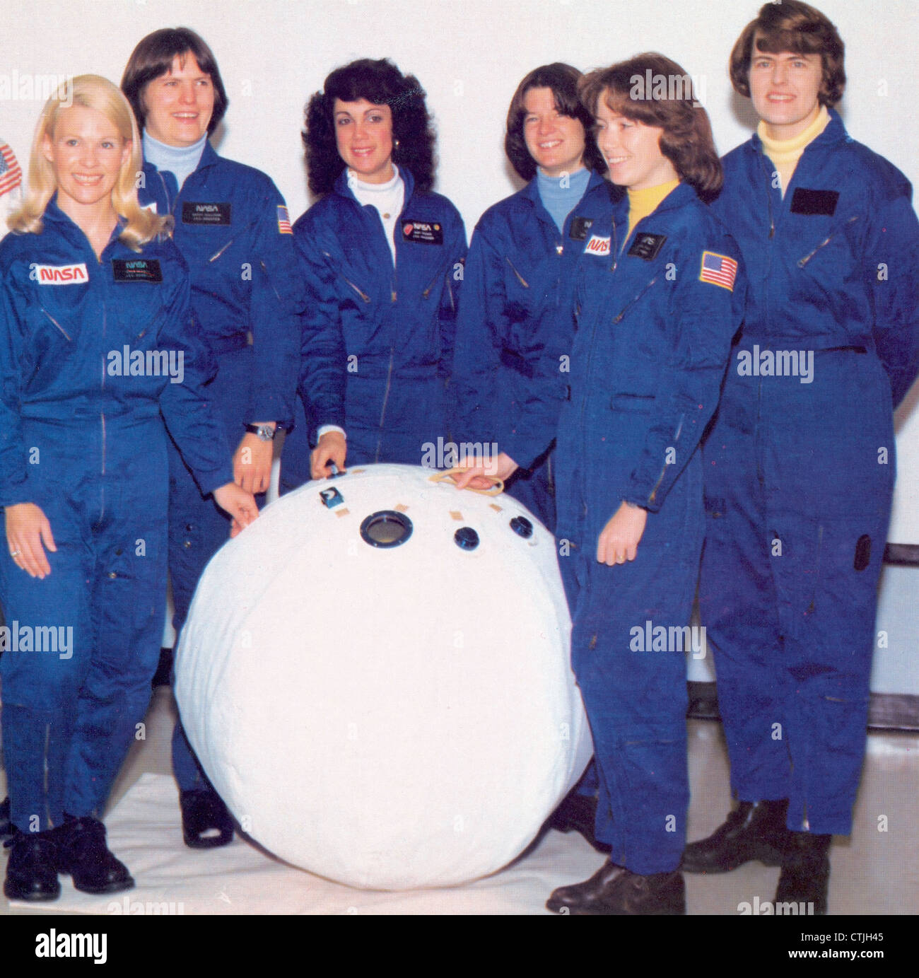 NASAs first six women astronauts from left to right, Margaret Seddon, Kathryn Sullivan, Judith Resnick, Sally Ride, Anna Fisher, and Shannon Lucid pose with a mockup of a personal rescue enclosure or rescue ball in the crew systems laboratory at the Johnson Space Center. The PRE was created as a possible means of transporting astronauts from one Shuttle to another in case of an emergency. Stock Photo