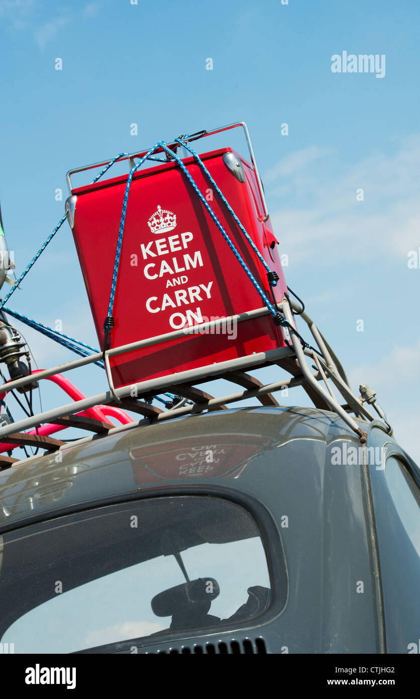 Keep calm and carry on retro style cool box strapped to the roof of an old VW Beetle car. UK Stock Photo