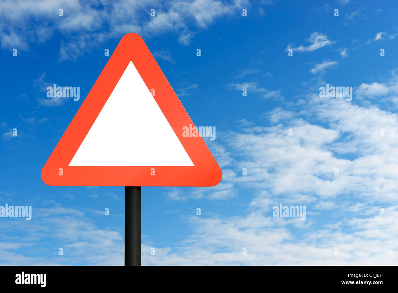 Red blank triangular road sign and blue sky Stock Photo