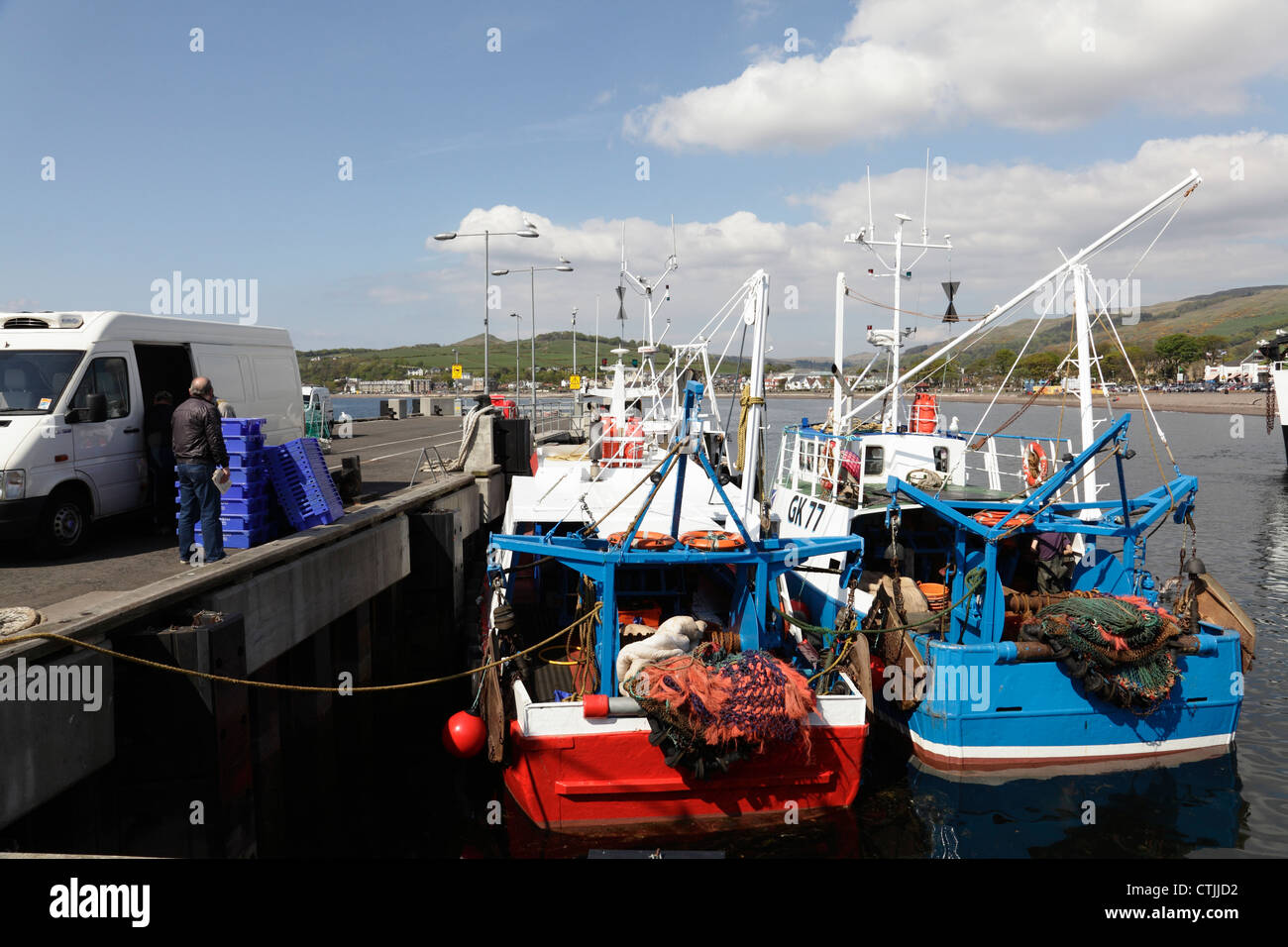 Small fishing boats landing their catch in Largs Harbour on the Firth of Clyde, North Ayrshire, Scotland, UK Stock Photo