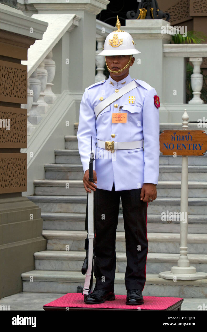 Guard wearing a white uniform at The Grand Palace in Bangkok, Thailand. Stock Photo