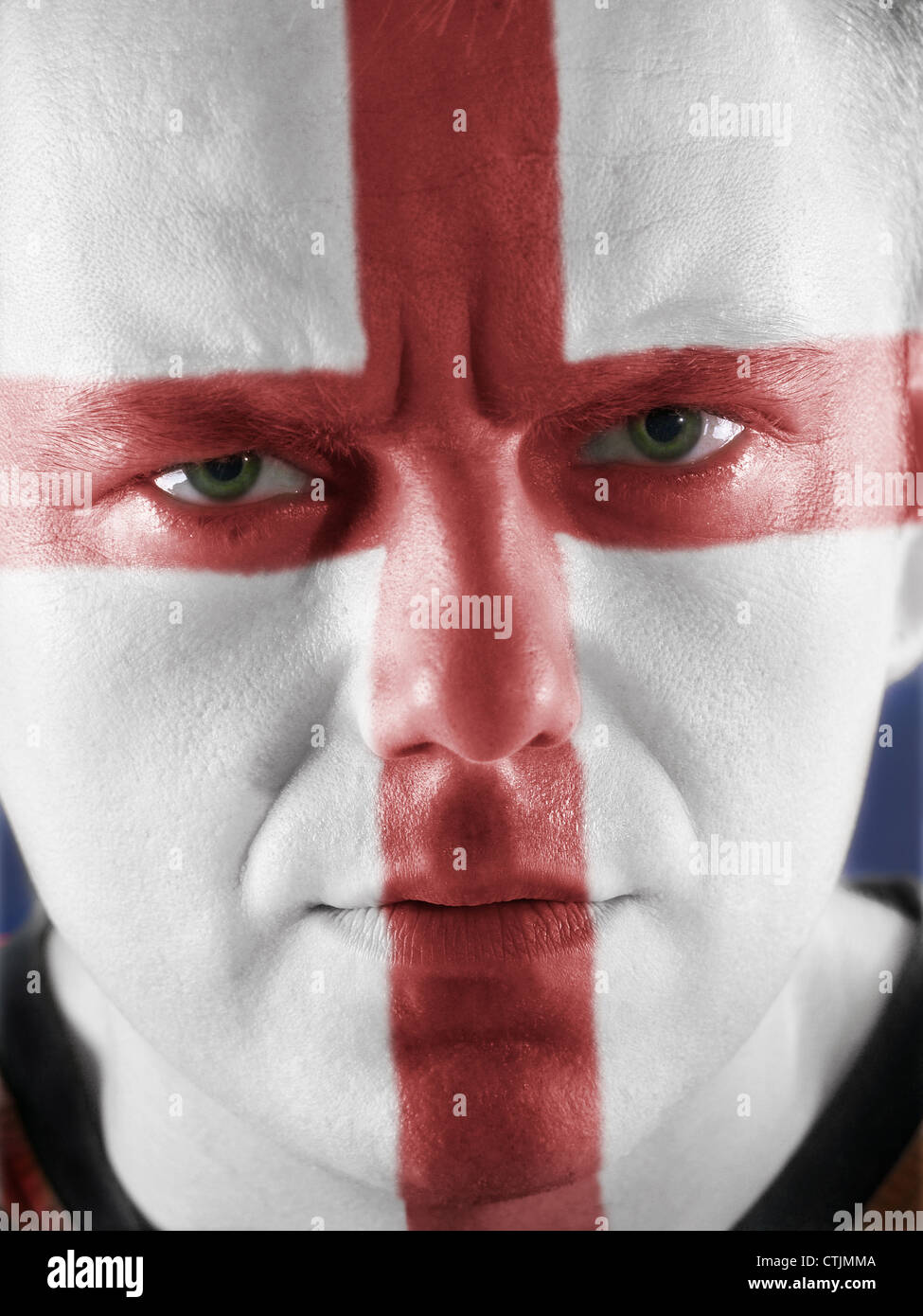 Closeup of young supporter of England face painted white with red cross Stock Photo