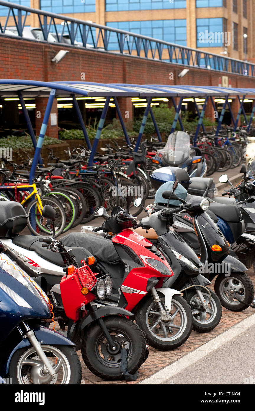 Bicycles and motorbikes parked securely in a parking area outside a