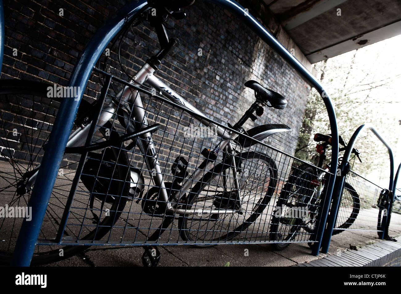 Bicycles parked securely outside a railway station in England. Stock Photo