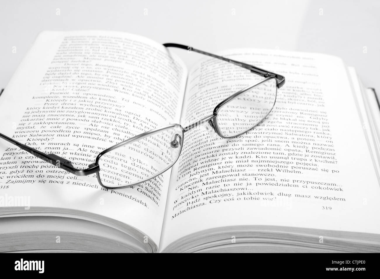 the reading glasses on a open book Stock Photo