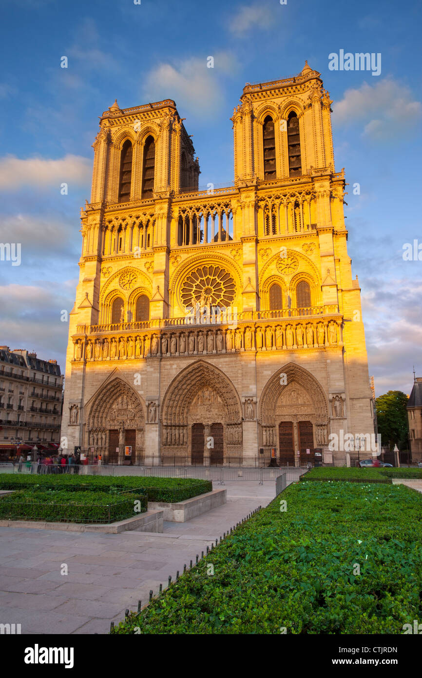 Setting sunlight glows on the facade of Cathedral Notre Dame, Paris France Stock Photo