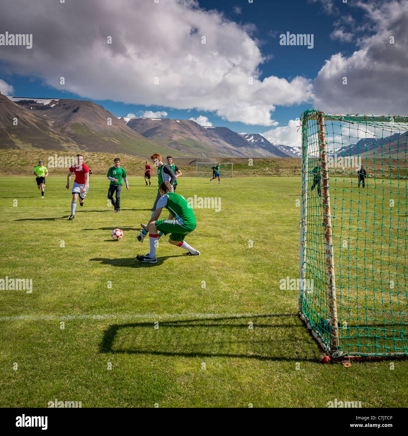 Teenagers playing football Hofsos, Iceland Stock Photo