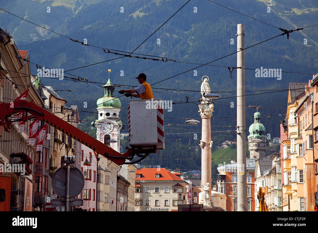 Cable lineman repairing transmission line in Maria Theresien Strasse, Innsbruck, Austria Stock
