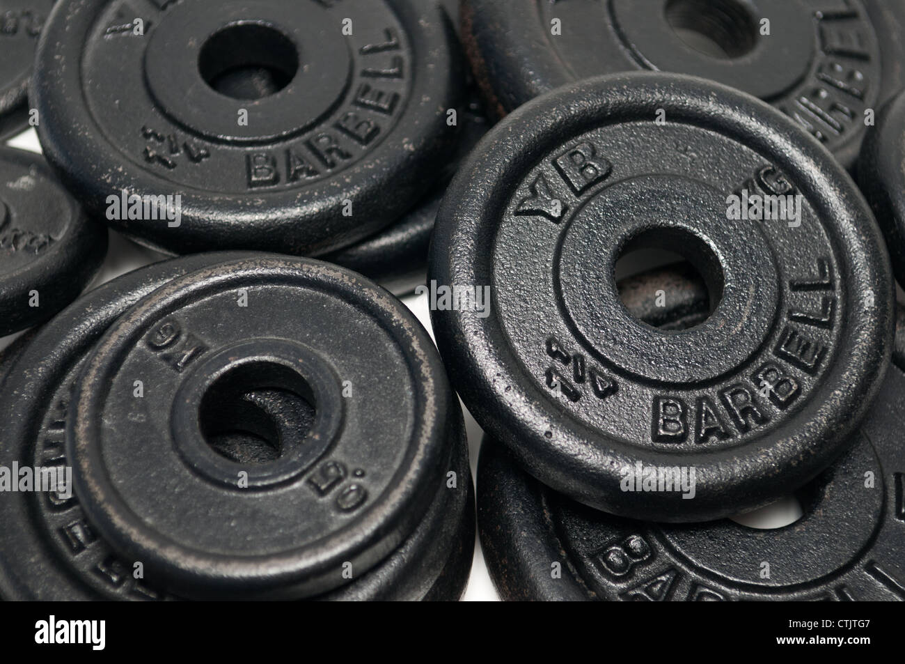 Pile of dumbbell weight discs Stock Photo