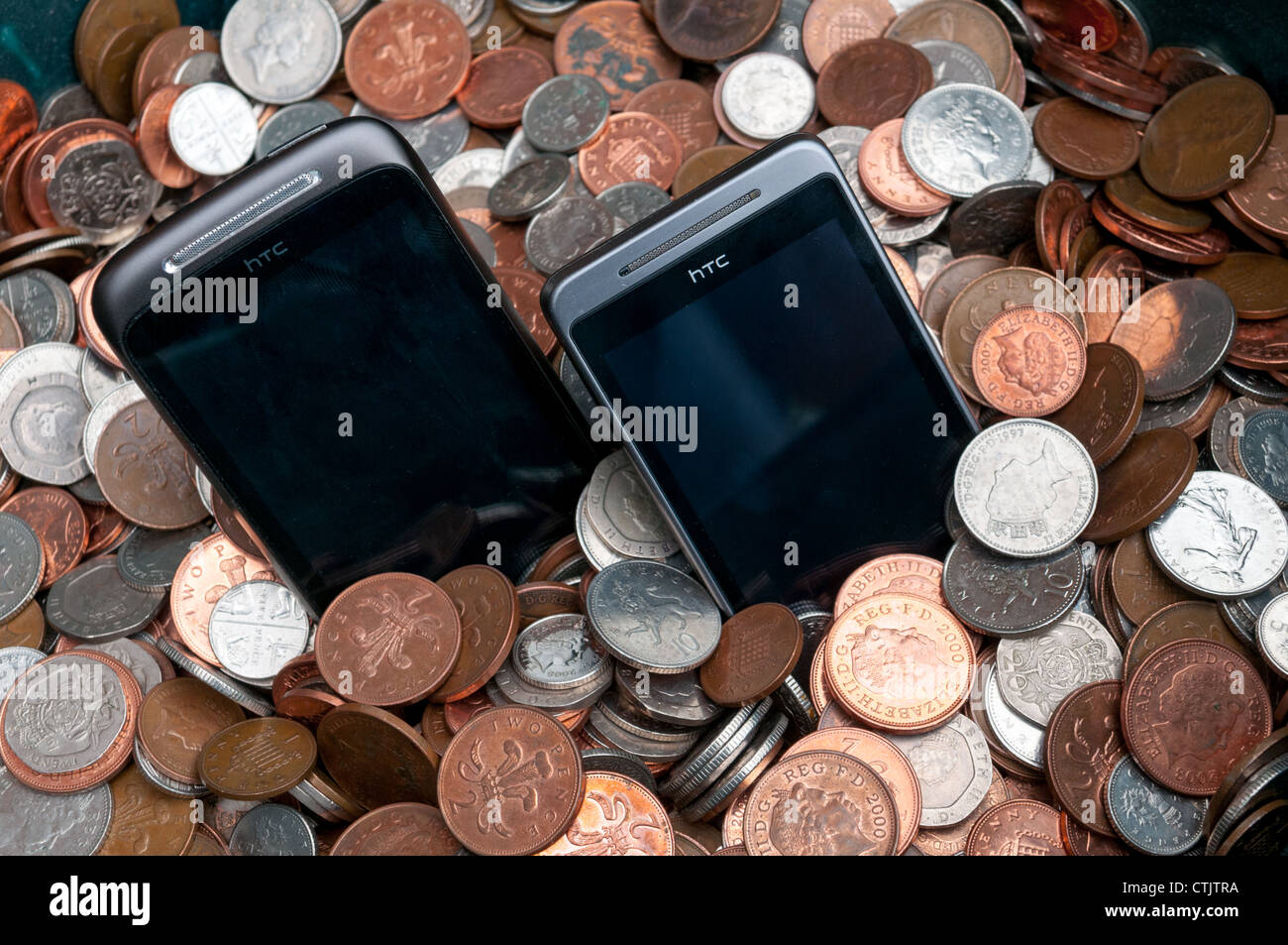 Mobile Phones on a pile of money Stock Photo