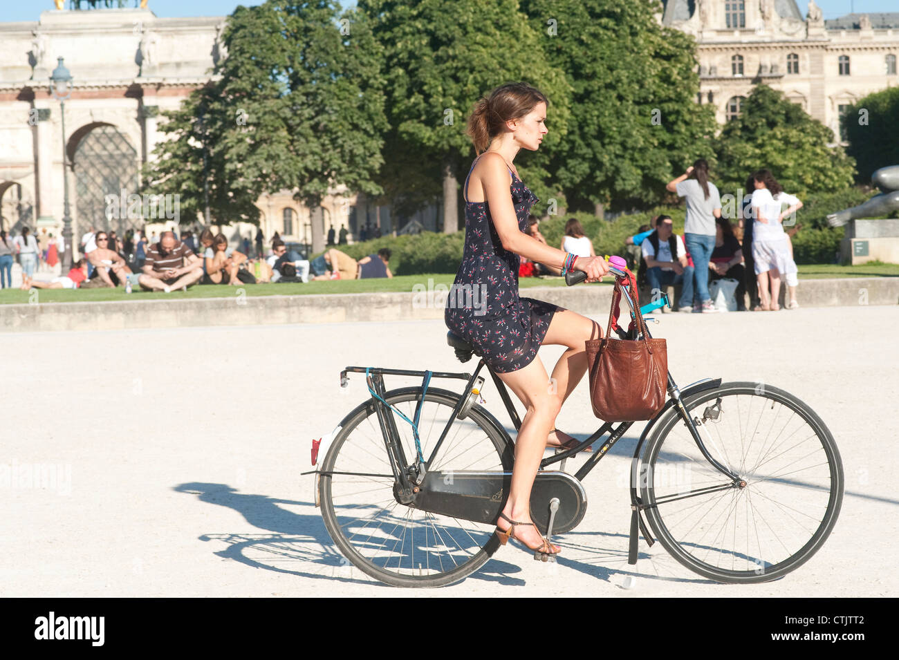 Paris France Young female riding bike at Arc De Triomphe du