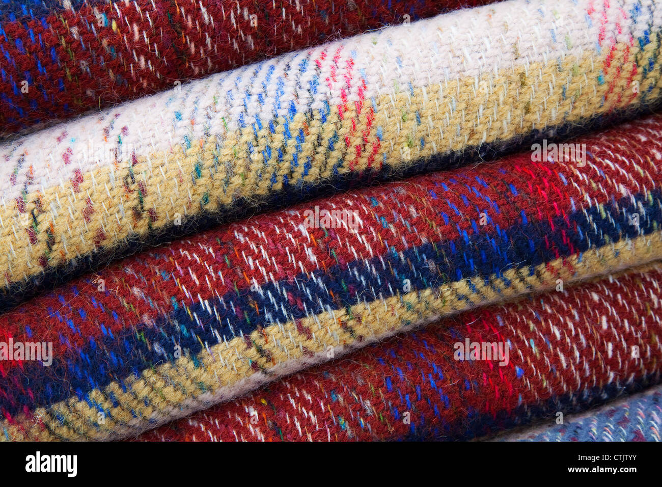 Woven patterned woollen blankets, blanket, woolen, wool, textile, fabric, texture, pattern, warm, soft, material, design, stacked and folded. Stock Photo