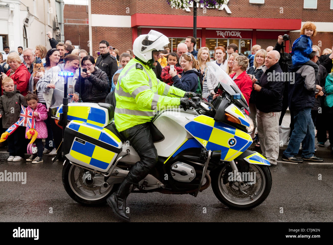 Policeman on motorcycle patrol, 2012 Olympic Torch relay, Newmarket Suffolk UK Stock Photo