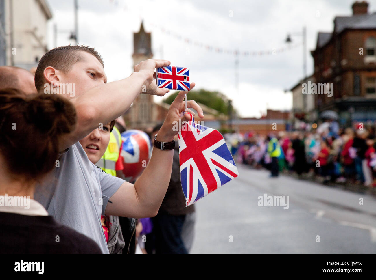 British town High street crowd during the 2012 olympic torch relay Newmarket Suffolk East Anglia UK Stock Photo