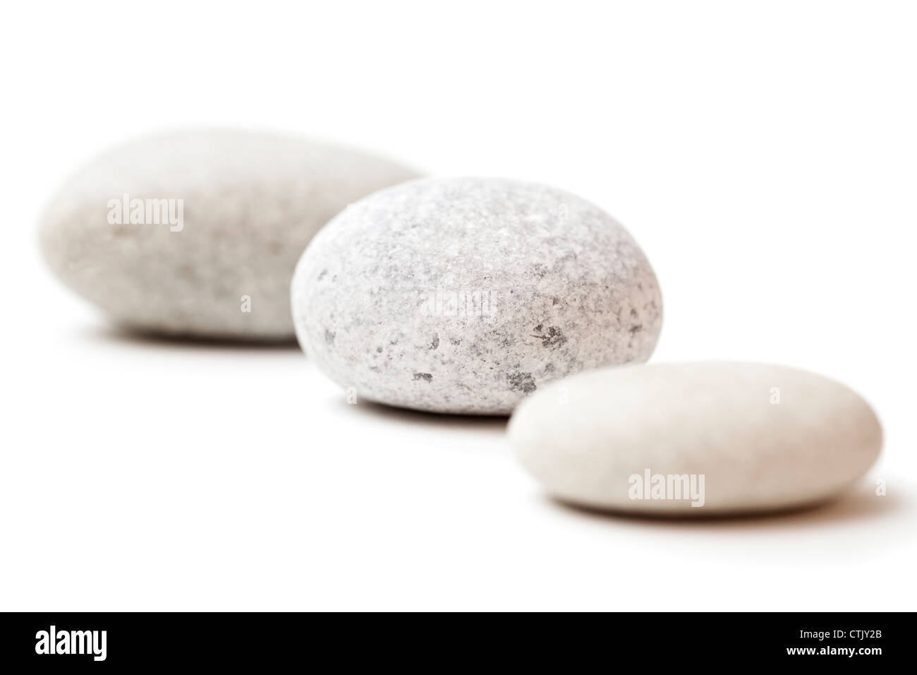 three gray spa stones isolated on white background Stock Photo
