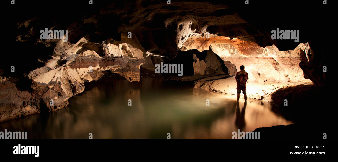A Filipino Tour Guide Holds A Lantern Inside Sumaging Cave Or Big Cave Near Sagada; Luzon, Philippines Stock Photo