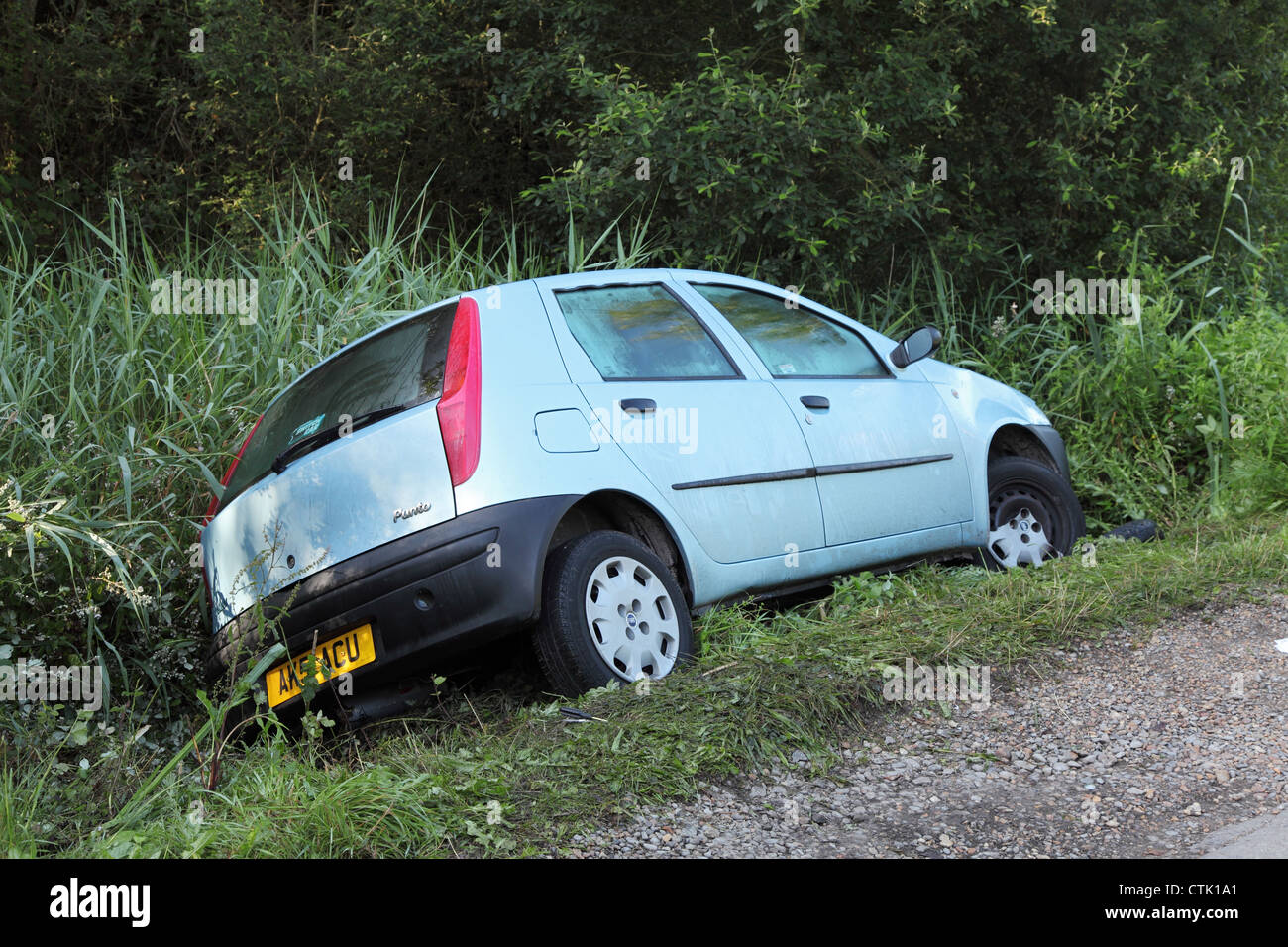Fiat Punto car in ditch following acute bend near Meon Shore, Fareham, England UK Stock Photo