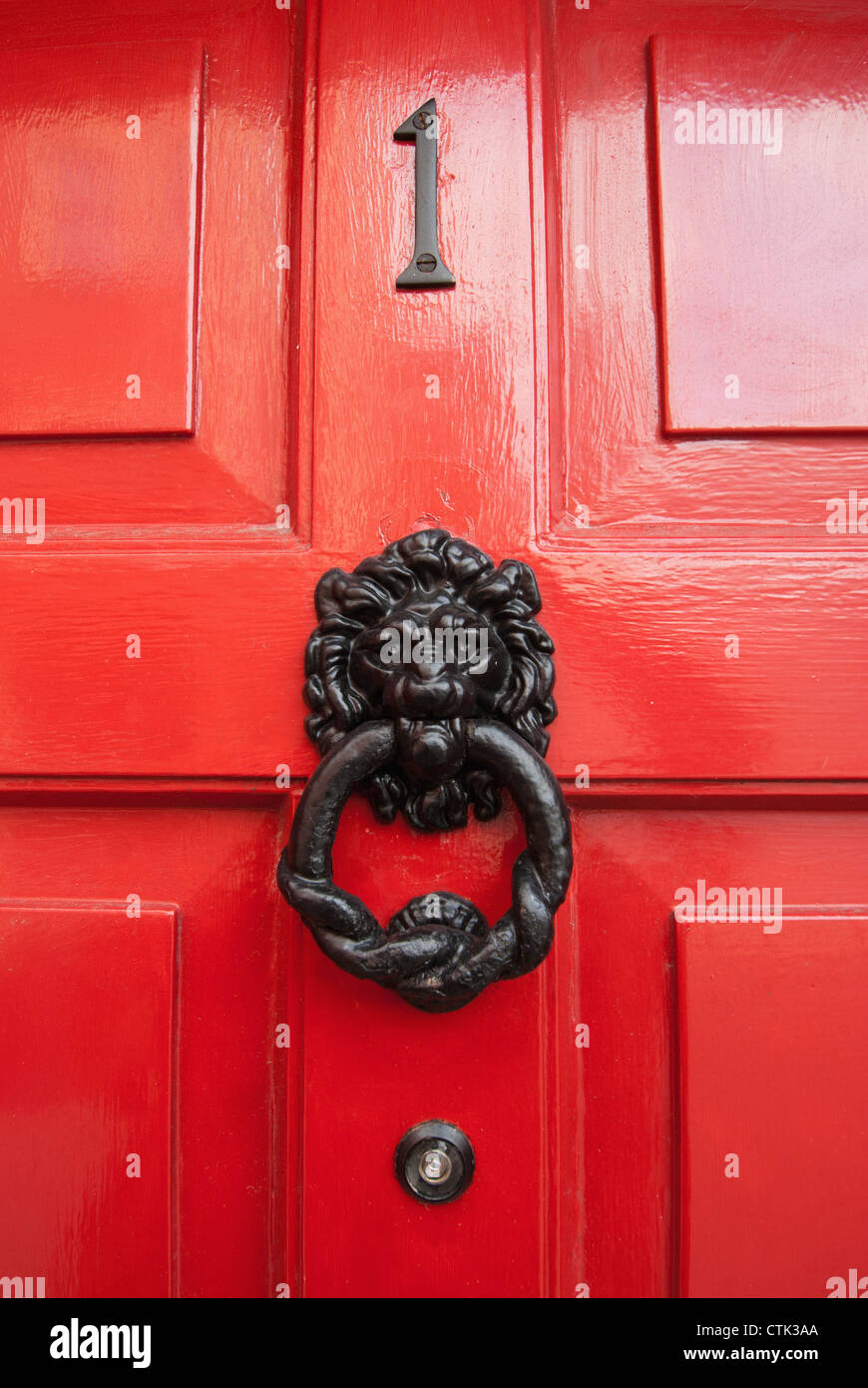 Lion Door Knocker On A Red Shiny Door; Ireland Stock Photo