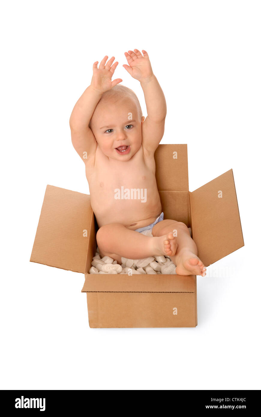 Happy one year old baby boy sitting in a cardboard box, with foam packing  peanuts Stock Photo - Alamy
