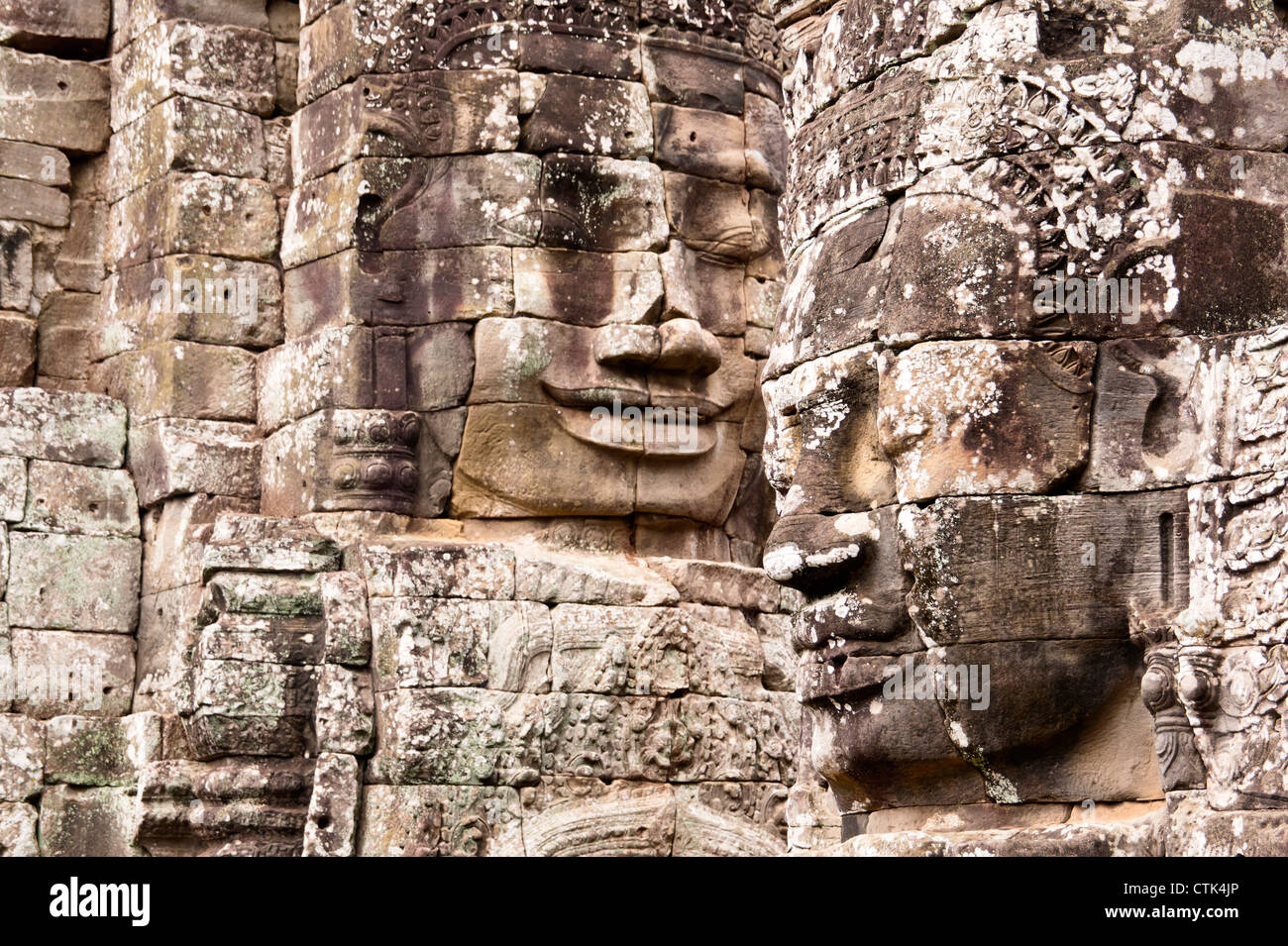 Two stone statue faces at Bayon, Cambodia Stock Photo Alamy