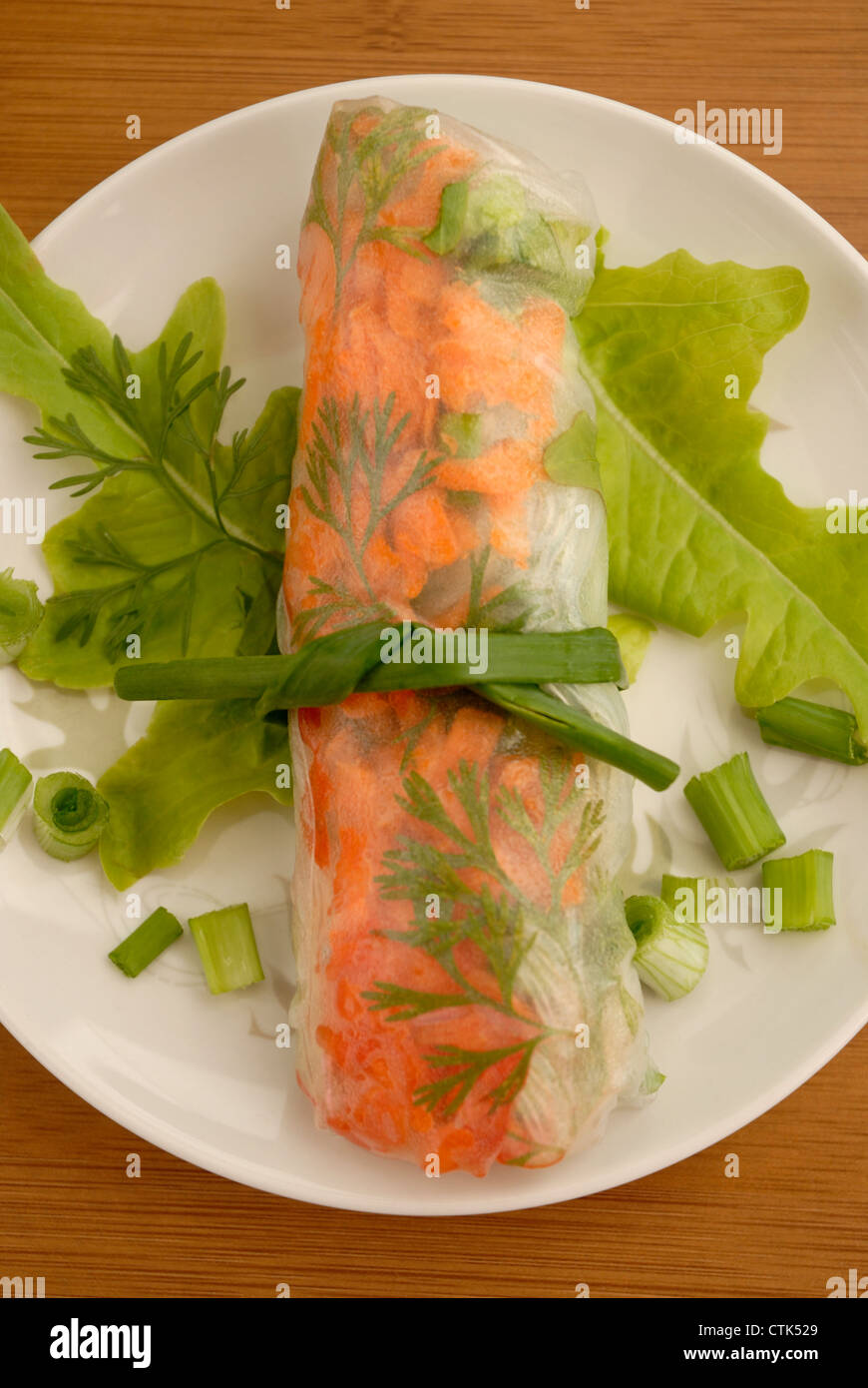 Vietnamese style Spring Roll, garnished and tied with a green onion. Stock Photo